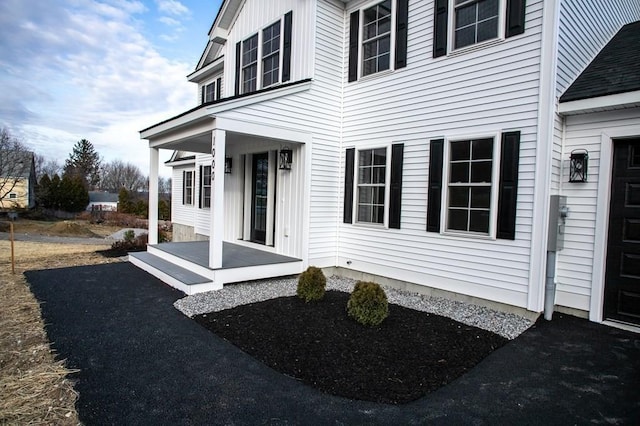 view of exterior entry featuring covered porch