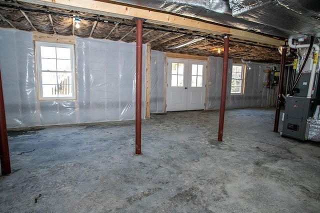 basement with plenty of natural light and heating unit