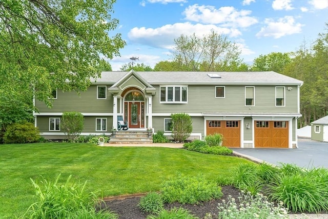 18 Sumac St, Billerica, MA 01821 - raised ranch featuring an attached garage, asphalt driveway, and a front lawn