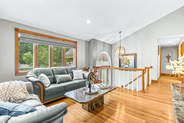 18 Sumac St, Billerica, MA 01821 - living area with lofted ceiling, light wood-style floors, a chandelier, and baseboards