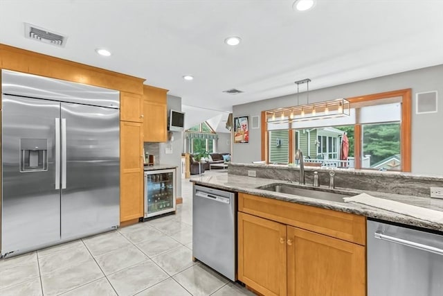 18 Sumac St, Billerica, MA 01821 - kitchen featuring appliances with stainless steel finishes, beverage cooler, a sink, light stone counters, and recessed lighting