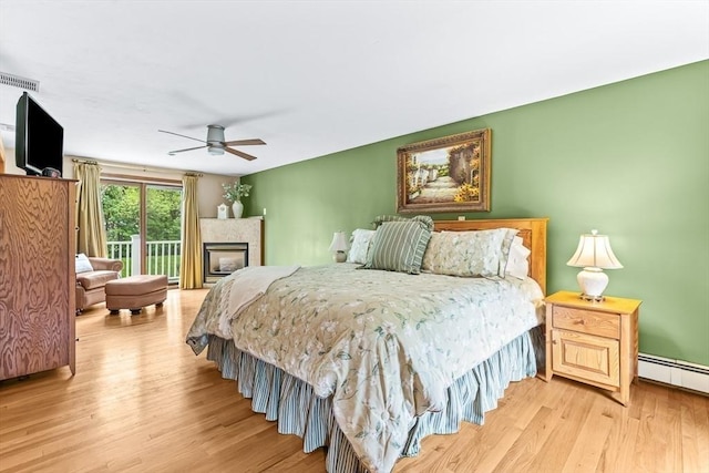 18 Sumac St, Billerica, MA 01821 - bedroom with wood finished floors, access to exterior, a baseboard heating unit, and ceiling fan