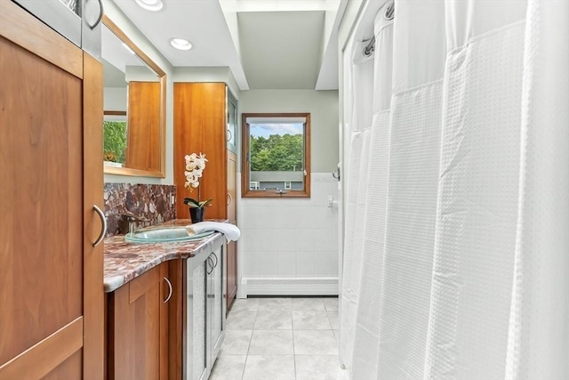 18 Sumac St, Billerica, MA 01821 - laundry area with baseboard heating, a sink, tile walls, and wainscoting