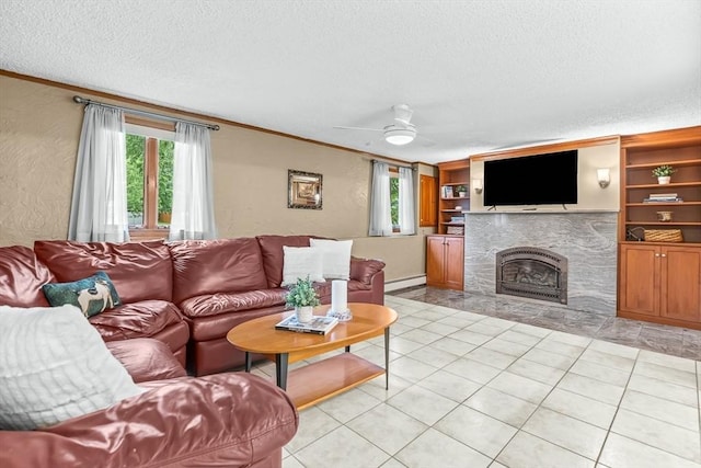 18 Sumac St, Billerica, MA 01821 - living area with a textured ceiling, crown molding, a ceiling fan, a tiled fireplace, and light tile patterned floors
