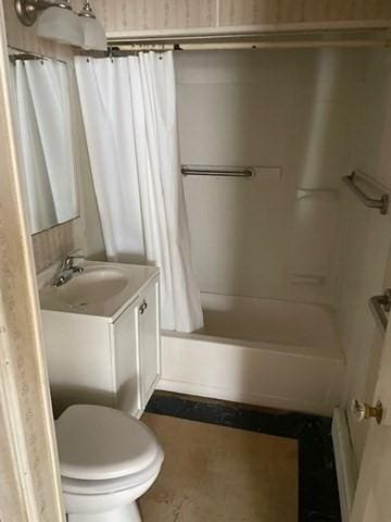 bathroom with toilet, shower / bath combo with shower curtain, and vanity