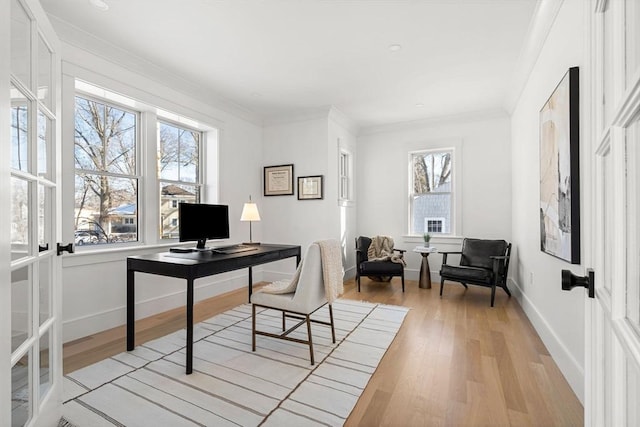 office area with ornamental molding and light hardwood / wood-style flooring