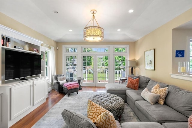 living room with wood finished floors, healthy amount of natural light, and recessed lighting