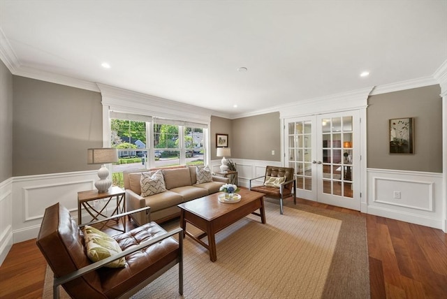 living room with french doors, a wainscoted wall, wood finished floors, a decorative wall, and ornamental molding