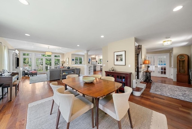 dining room featuring french doors, wood finished floors, ornate columns, and recessed lighting