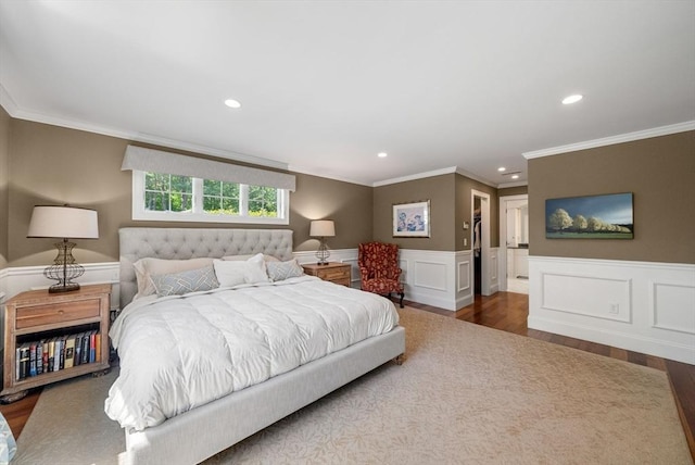 bedroom with wood finished floors, recessed lighting, wainscoting, and crown molding