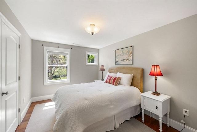 bedroom featuring baseboards and wood finished floors