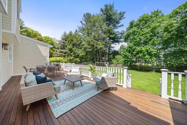 deck with outdoor dining area, an outdoor living space, and view of wooded area