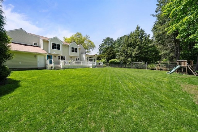 view of yard with a playground and a wooden deck