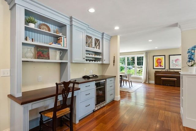 kitchen featuring wine cooler, open shelves, dark wood finished floors, dark countertops, and recessed lighting