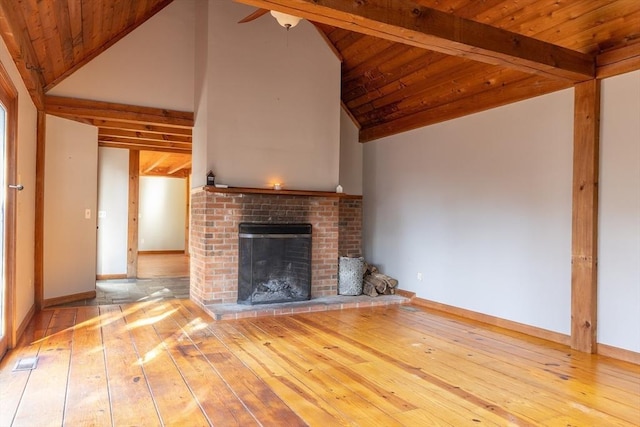 unfurnished living room featuring hardwood / wood-style floors, a fireplace, and baseboards