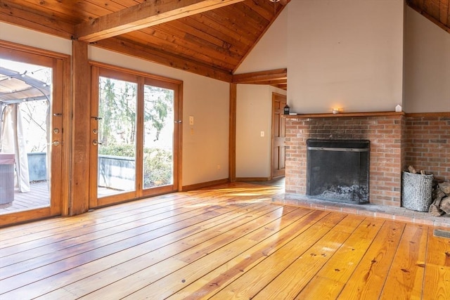 unfurnished living room with high vaulted ceiling, wood-type flooring, wooden ceiling, baseboards, and a brick fireplace