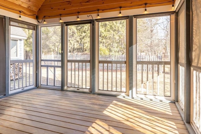 unfurnished sunroom with lofted ceiling