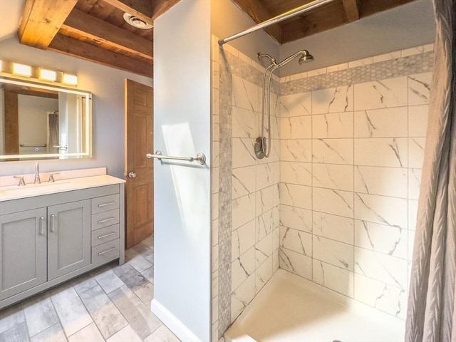 full bath featuring vaulted ceiling with beams, a shower stall, and vanity