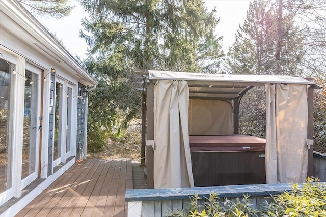 wooden deck with a hot tub