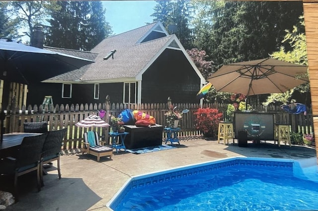 view of pool with a fenced in pool, a patio, and fence