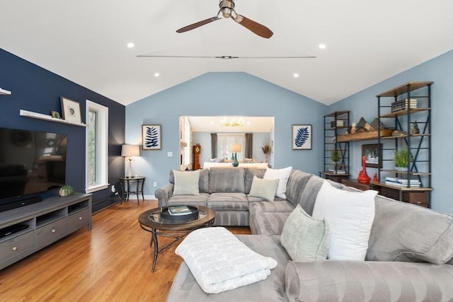 living area with light wood finished floors, recessed lighting, vaulted ceiling, and ceiling fan with notable chandelier