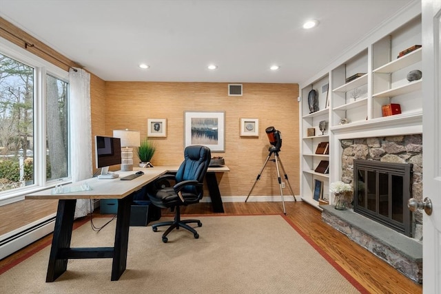 office featuring recessed lighting, visible vents, plenty of natural light, and wood finished floors