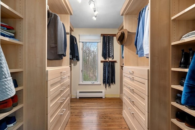 walk in closet with baseboard heating and light wood-style flooring