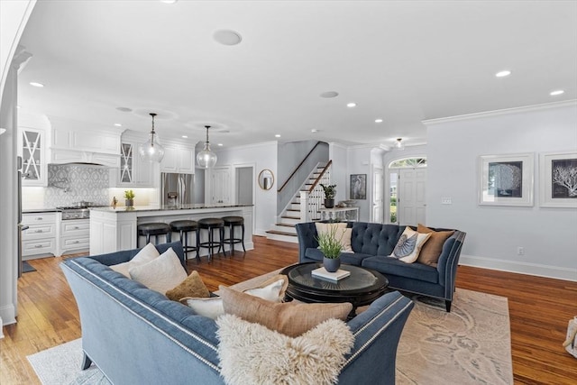 living room featuring ornamental molding and light hardwood / wood-style floors