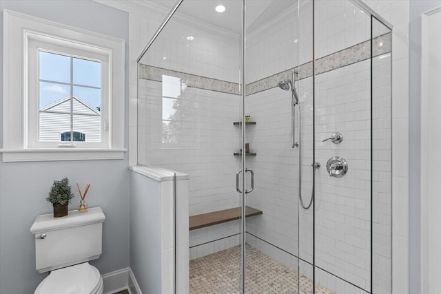 bathroom with walk in shower, ornamental molding, and toilet