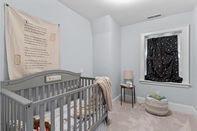 carpeted bedroom with a crib