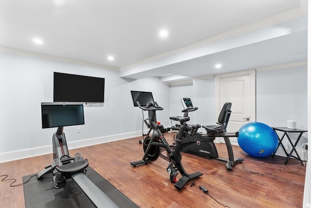 workout area featuring crown molding and wood-type flooring