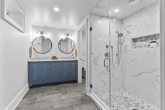 bathroom featuring an enclosed shower, vanity, and toilet