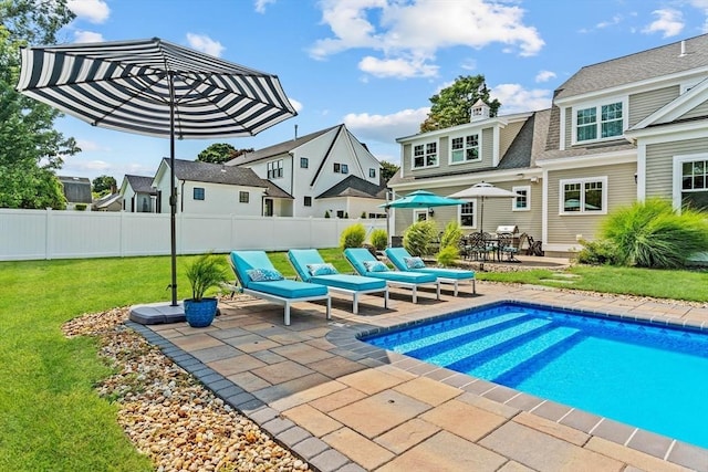 view of pool featuring a patio and a lawn