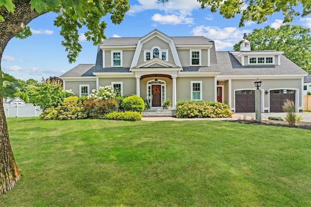 view of front of house with a garage and a front yard