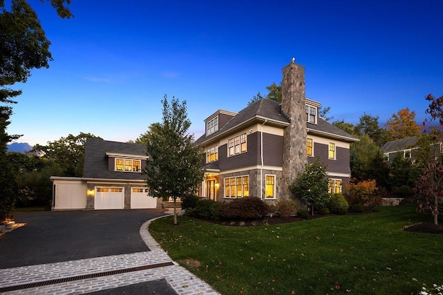 view of front property with a garage and a yard