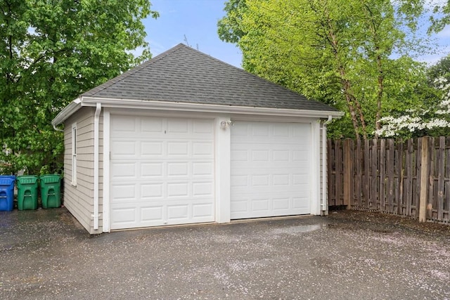 detached garage featuring fence