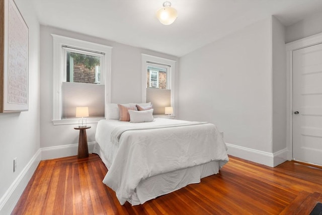 bedroom featuring baseboards and wood finished floors