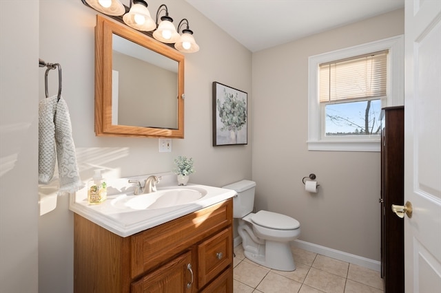 bathroom featuring tile patterned flooring, vanity, and toilet