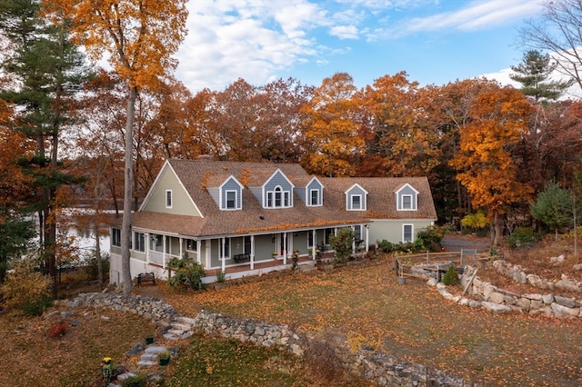 cape cod-style house featuring a porch