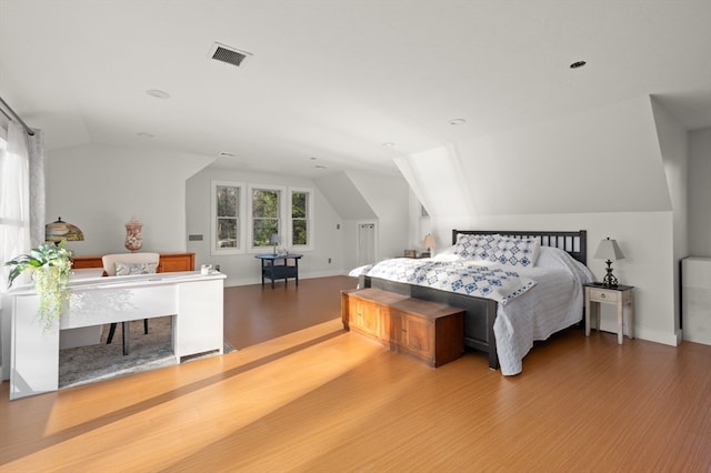 bedroom with lofted ceiling and hardwood / wood-style flooring