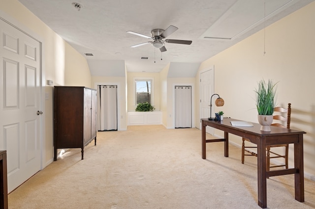 office space featuring light colored carpet, ceiling fan, and lofted ceiling