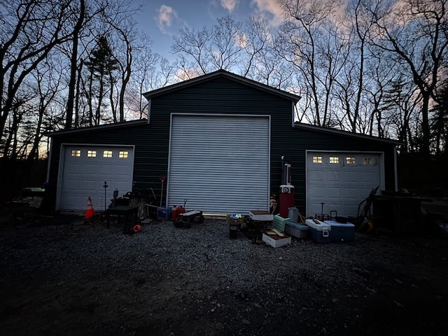 view of garage at dusk