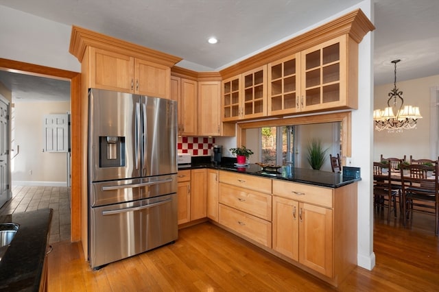 kitchen featuring a chandelier, stainless steel fridge with ice dispenser, light brown cabinets, and light hardwood / wood-style floors