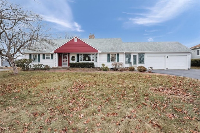 ranch-style house featuring a front lawn and a garage