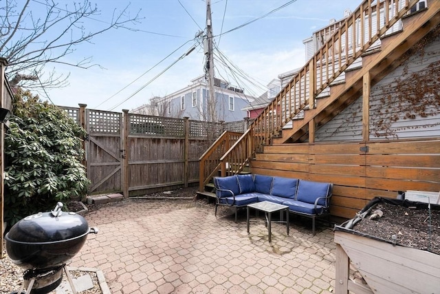view of patio with stairway, fence, grilling area, and an outdoor hangout area