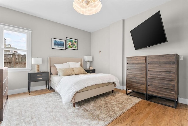 bedroom featuring baseboards and wood finished floors