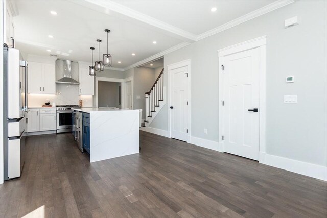 kitchen featuring a kitchen island, high end stove, freestanding refrigerator, dark wood-style floors, and wall chimney exhaust hood