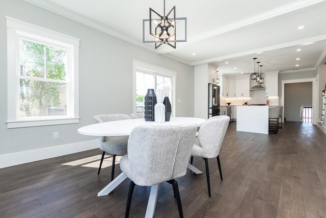 dining room featuring a chandelier, dark wood-style floors, and a healthy amount of sunlight