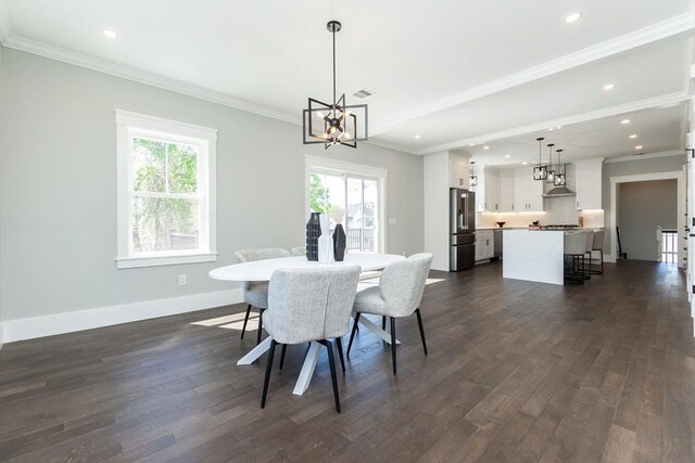dining room with visible vents, crown molding, baseboards, dark wood-style floors, and a chandelier