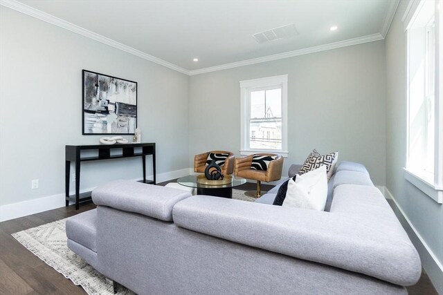 living area featuring visible vents, ornamental molding, and a healthy amount of sunlight